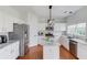 Modern kitchen featuring granite countertops, white cabinetry, and stainless steel appliances at 243 Wedmore Ct, Suwanee, GA 30024