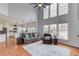 Open-concept living room with high ceilings and a view into kitchen at 243 Wedmore Ct, Suwanee, GA 30024