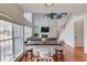 View of the living room from a breakfast bar, showcasing the fireplace and natural light at 243 Wedmore Ct, Suwanee, GA 30024