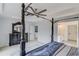 Spacious main bedroom featuring a four-poster bed, ceiling fan, and tray ceiling at 243 Wedmore Ct, Suwanee, GA 30024