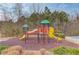 Community playground with slides, climbing areas, and a wood chip ground cover at 243 Wedmore Ct, Suwanee, GA 30024