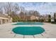 Community pool covered with a safety tarp surrounded by a large pool deck at 243 Wedmore Ct, Suwanee, GA 30024