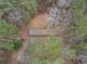 Aerial view of a mobile home with tin roof and surrounding trees at 559 Quail Trail Rd, Auburn, GA 30011