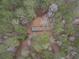 Mobile home and tin roofed structure as seen from above among treetops at 559 Quail Trail Rd, Auburn, GA 30011