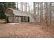 A metal carport with a concrete base nestled in the woods at 559 Quail Trail Rd, Auburn, GA 30011