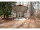 Spacious carport with room for vehicles and storage in wooded setting at 559 Quail Trail Rd, Auburn, GA 30011