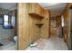 Hallway features wood paneling, and leads to bathroom with shower curtain at 559 Quail Trail Rd, Auburn, GA 30011