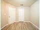 Bedroom with neutral walls, light-colored wood flooring, and two white doors at 327 Brookside Dr, Mcdonough, GA 30253