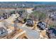 Residential neighborhood aerial view showcases well-maintained homes with mature trees and winding roads, and a body of water at 1677 Angelica Ct, Lawrenceville, GA 30043