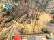 Aerial view of landscaped backyard, a pool and multi-level decks with outdoor seating at 1677 Angelica Ct, Lawrenceville, GA 30043