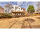 View of the house and backyard, with a multi-level deck, patio, and lush landscaping at 1677 Angelica Ct, Lawrenceville, GA 30043