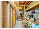 Unfinished basement, featuring exposed beams, shelving and ample space for storage at 1677 Angelica Ct, Lawrenceville, GA 30043