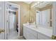 Well-lit bathroom with white cabinets, large mirror, and gold hardware at 1677 Angelica Ct, Lawrenceville, GA 30043