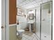 Cozy bathroom featuring a pedestal sink, tiled floors, and a glass shower enclosure at 1677 Angelica Ct, Lawrenceville, GA 30043