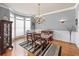 Formal dining room with hardwood floors, large windows, and elegant chandelier at 1677 Angelica Ct, Lawrenceville, GA 30043