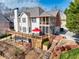 Back exterior featuring multi-level decks and a landscaped yard with a red umbrella at 1677 Angelica Ct, Lawrenceville, GA 30043