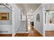 Inviting foyer with hardwood floors, elegant staircase, and views into the living spaces at 1677 Angelica Ct, Lawrenceville, GA 30043