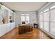 Bright home office with large windows, built-in shelving, and a classic wooden desk at 1677 Angelica Ct, Lawrenceville, GA 30043