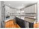 A spacious kitchen featuring an island with a granite countertop, stainless steel appliances, and light-colored cabinets at 1677 Angelica Ct, Lawrenceville, GA 30043