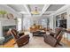 Elegant living room showcasing coffered ceilings, a fireplace, and large windows at 1677 Angelica Ct, Lawrenceville, GA 30043