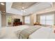 The main bedroom featuring a tray ceiling, carpet, neutral walls, large windows, and access to the outside deck at 1677 Angelica Ct, Lawrenceville, GA 30043