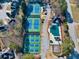 Aerial shot of tennis courts and a pool surrounded by lush greenery, offering recreational amenities at 1677 Angelica Ct, Lawrenceville, GA 30043