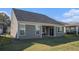 View of the backyard with a sliding glass door leading to the patio of the home at 24 Aspen Way, Dallas, GA 30157