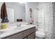 Bathroom with granite countertop, a decorative shower curtain, and white cabinetry at 24 Aspen Way, Dallas, GA 30157