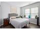 Cozy bedroom with a padded headboard, wooden floors, and natural lighting at 24 Aspen Way, Dallas, GA 30157