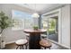 Cozy dining area with a rustic table, bar stool seating, and sliding glass door access to the backyard at 24 Aspen Way, Dallas, GA 30157