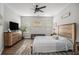 Relaxing main bedroom with neutral decor, hardwood floors, and large windows for ample natural light at 24 Aspen Way, Dallas, GA 30157