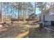 Spacious backyard featuring mature trees and a well-maintained lawn, providing ample space for outdoor activities at 3225 Redona Dr, Atlanta, GA 30349