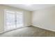 Bedroom with glass paneled doors and fresh grey carpet at 3225 Redona Dr, Atlanta, GA 30349