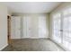 Bedroom featuring glass doors and fresh grey carpet and two doors at 3225 Redona Dr, Atlanta, GA 30349