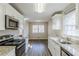 Bright kitchen with white cabinets, granite countertops, stainless appliances, and an adjacent dining area at 3225 Redona Dr, Atlanta, GA 30349