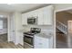 Kitchen with white cabinets, granite countertops, stainless steel appliances and an oven range at 3225 Redona Dr, Atlanta, GA 30349