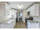 Galley kitchen featuring white cabinets, granite counters, and stainless steel appliances at 3225 Redona Dr, Atlanta, GA 30349