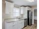 Kitchen featuring white cabinets, granite counters, stainless steel appliances, and a window at 3225 Redona Dr, Atlanta, GA 30349