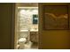 Bathroom with stacked stone accent wall, updated vanity, new toilet and tile flooring, artwork on wall nearby at 620 Peachtree Ne St # 502, Atlanta, GA 30308