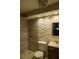 Bathroom featuring walk-in shower, decorative stacked stone wall, updated vanity with tile flooring at 620 Peachtree Ne St # 502, Atlanta, GA 30308