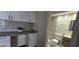 Bathroom with white vanity featuring stacked stone accent wall and natural countertop, next to the beautifully tiled bathroom at 620 Peachtree Ne St # 502, Atlanta, GA 30308