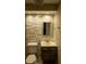 Bathroom featuring stacked stone accent wall, updated vanity, new toilet and tile flooring at 620 Peachtree Ne St # 502, Atlanta, GA 30308