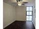 Bedroom with a ceiling fan, dark floors, and natural light from a large window at 620 Peachtree Ne St # 502, Atlanta, GA 30308