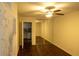 Cozy bedroom with a ceiling fan, wood floors, and closet with mirrored sliding doors at 620 Peachtree Ne St # 502, Atlanta, GA 30308