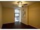 Bedroom with dark floors, ceiling fan, and a window to the outdoor scenery at 620 Peachtree Ne St # 502, Atlanta, GA 30308