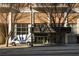 Front exterior featuring a sign, an awning and trees framing the entrance at 620 Peachtree Ne St # 502, Atlanta, GA 30308