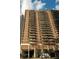 Tall brick apartment building featuring multiple balconies and city views on a partly cloudy day at 620 Peachtree Ne St # 502, Atlanta, GA 30308