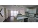 Kitchen features white cabinets, marble countertops, stainless steel appliances, and view of the balcony at 620 Peachtree Ne St # 502, Atlanta, GA 30308