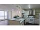 A modern kitchen with white cabinets, stainless steel appliances, marble countertops, and a balcony view at 620 Peachtree Ne St # 502, Atlanta, GA 30308