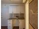 Functional office space featuring granite countertop, mosaic backsplash, and white cabinetry providing a perfect place to work at 620 Peachtree Ne St # 502, Atlanta, GA 30308